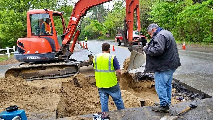 Crew working with an excavator on a road connection